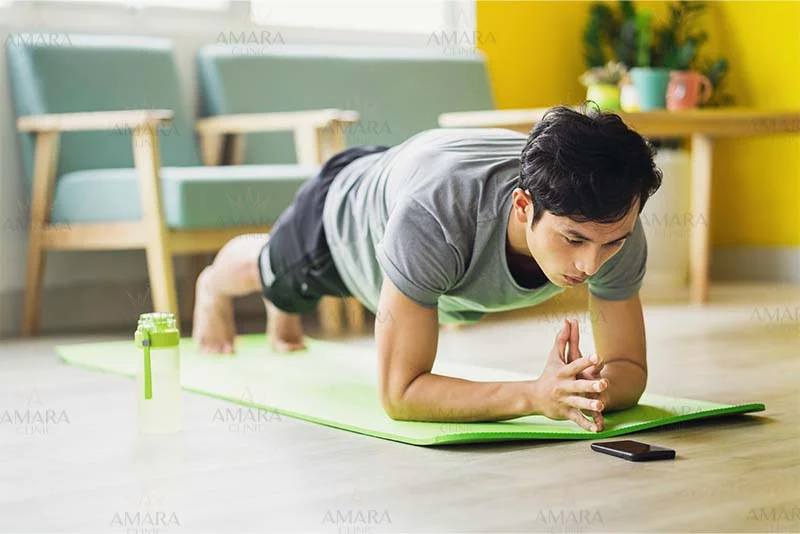 A man does the plank to reduce belly pooch